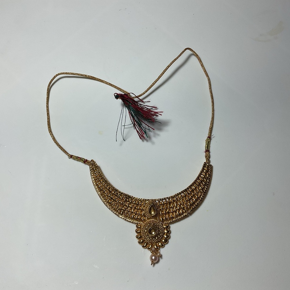 Gold Crescent Necklace with Intricate Design and Tassel